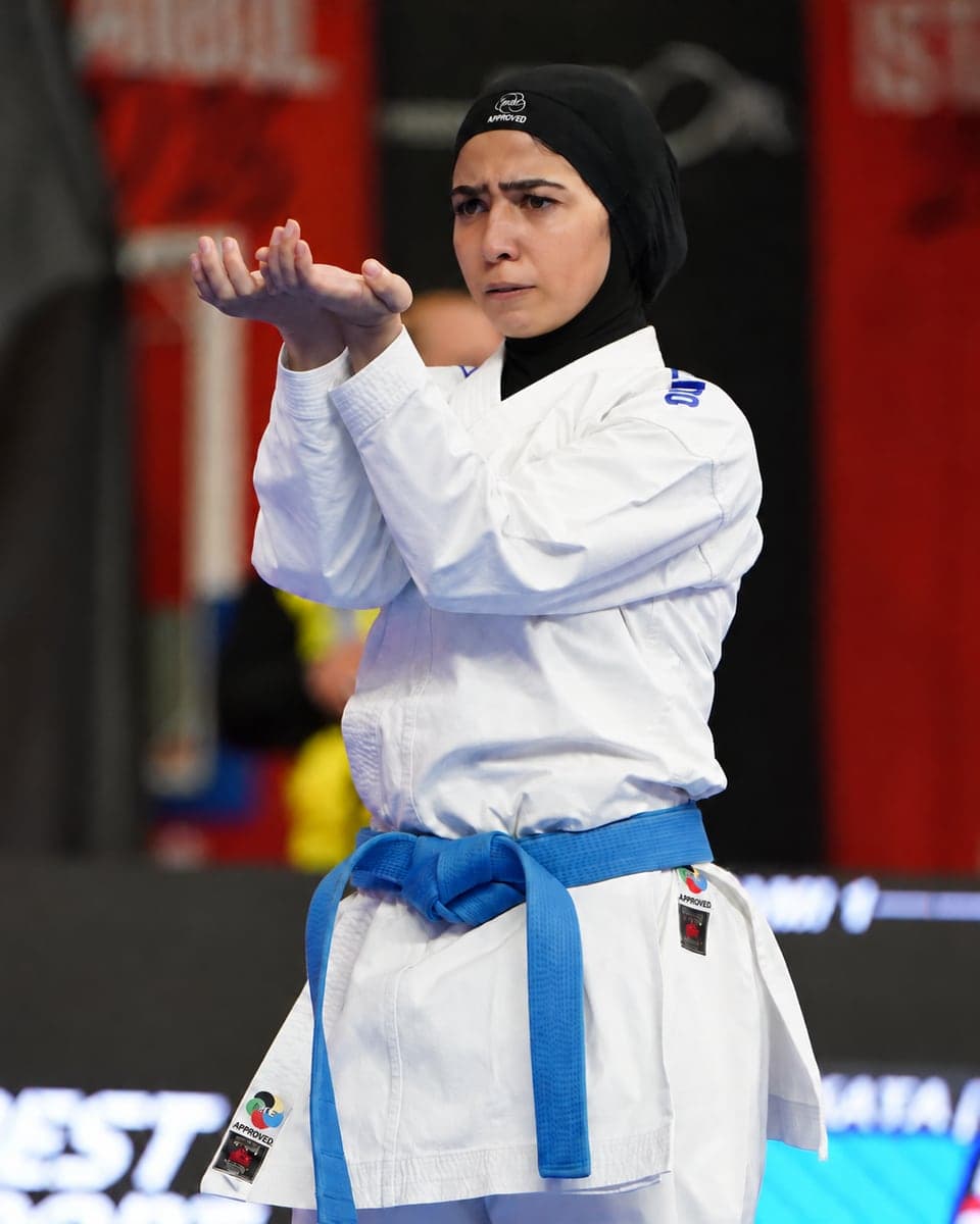 Jana Khamis holding a kata guard position on the competition mat.